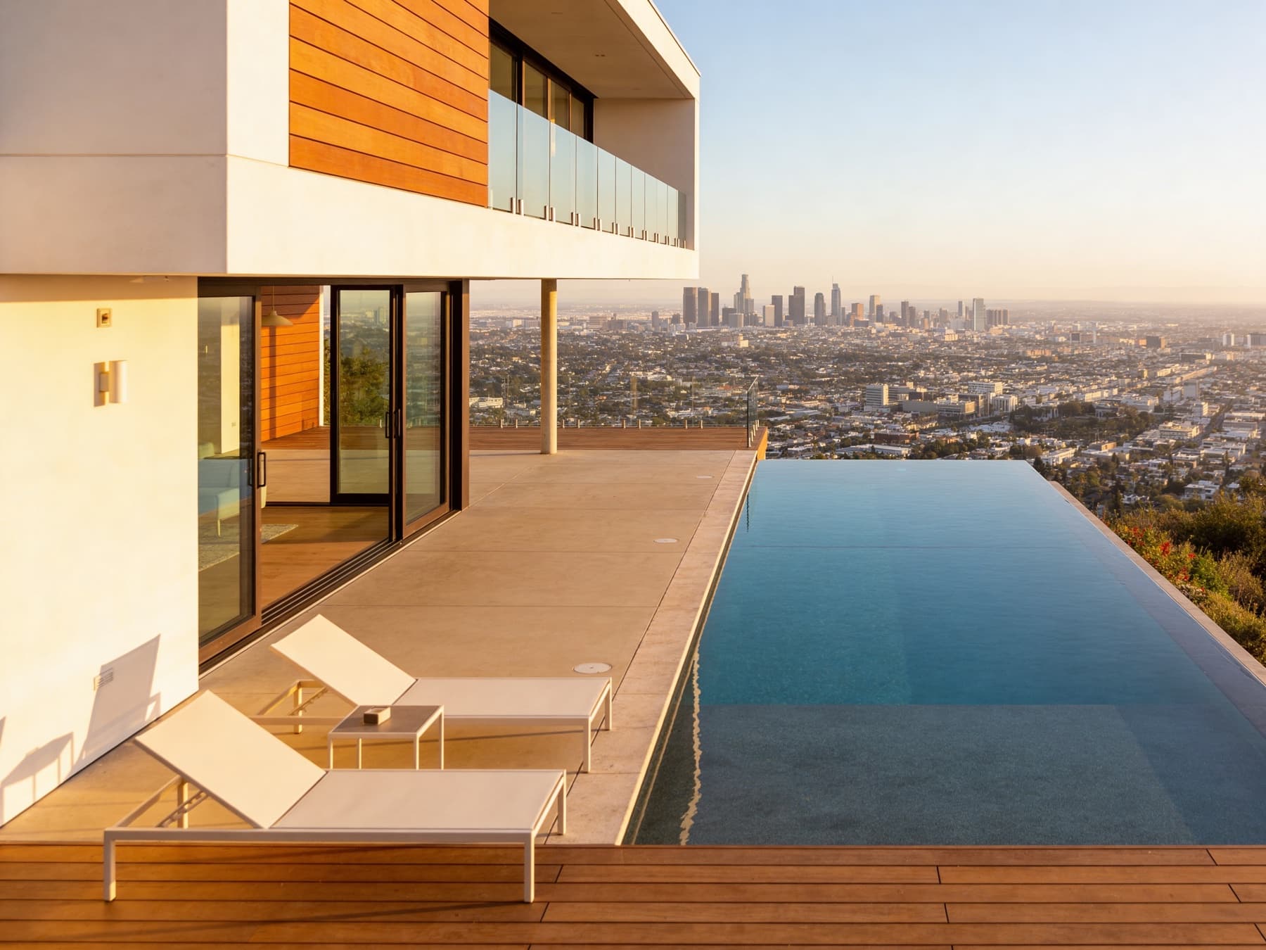 Outdoor terrace with infinity pool at dusk